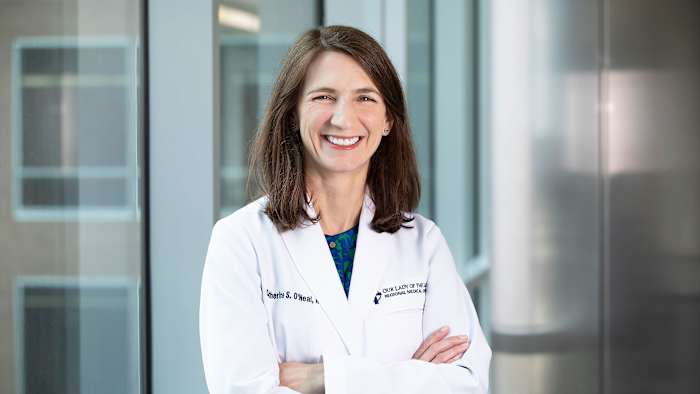 Dr. Katie O’Neal poses with her arms folded